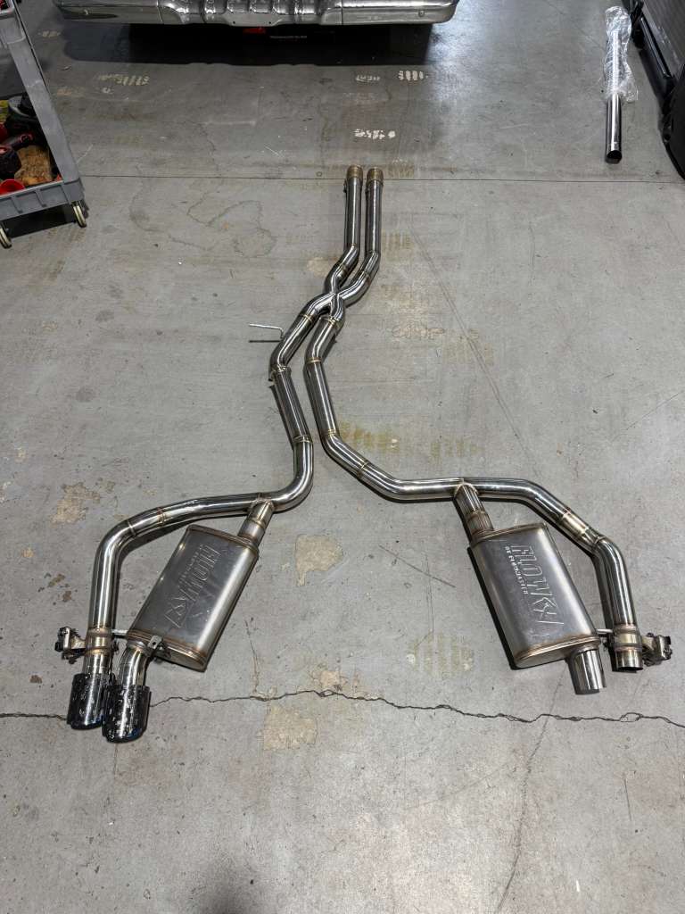 Custom exhaust components laid out on the shop floor