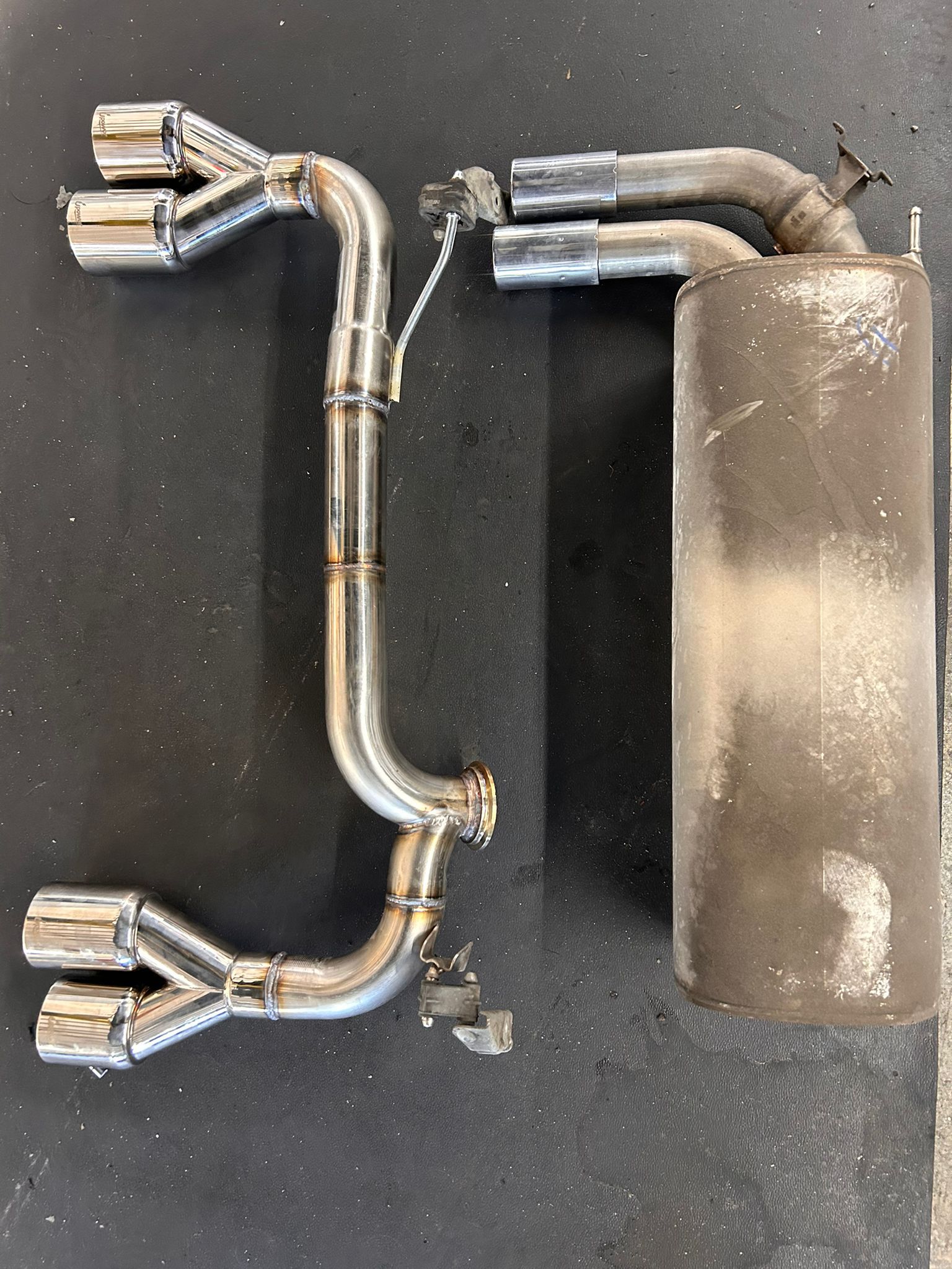 Custom exhaust work beside the original part